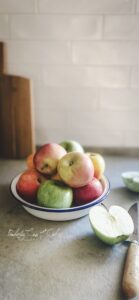 Apple cut in half plus knife